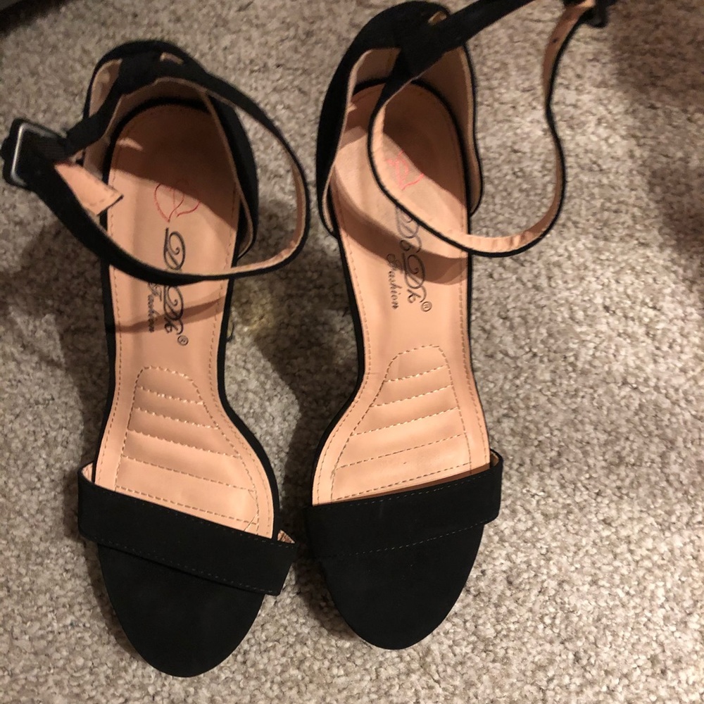 Tall black heels with gold heel
